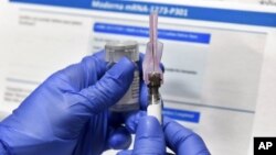 ARHIVA - Medicinska sestra priprema probnu vakcinu protiv Kovida 19 koju razvijaju Nacionalni instituti za zdravlje i kompanija Moderna (Foto: AP/Hans Pennink)
