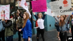 Participants take a stand against sexual assault and harassment for the #MeToo March in the Hollywood district of Los Angeles on Nov. 12, 2017. 