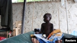 A South Sudanese child suffering from cholera sits on a bed in Juba Teaching Hospital in Juba, May 27, 2014. 