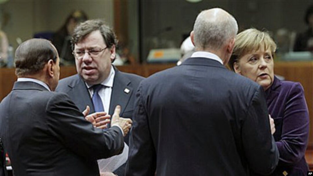 From left to right, Italy's Prime Minister Silvio Berlusconi, Irish Prime Minister Brian Cowen, Greek Prime Minister George Papandreou and German Chancellor Angela Merkel share a word during an EU summit in Brussels, Dec 16, 2010