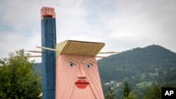 FILE - A wooden statue resembling Donald Trump was built near Kamnik, Slovenia. 