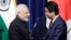 Indian Prime Minister Narendra Modi, left, and Japan's Prime Minister Shinzo Abe face during a joint news conference at Abe's official residence in Tokyo, Oct. 29, 2018. 