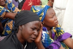 FILE - Mothers of the missing Chibok schoolgirls abducted by Boko Haram gather to receive information from officials, May 5, 2014.