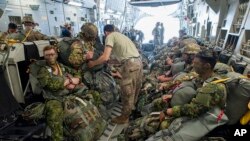 FILE - Paratroopers prepare for deployment onboard a US aircraft during the Swift Response 2017 international military exercise at Papa Airbase near Papa, 146 kms southwest of Budapest, Hungary, July 18, 2017. 