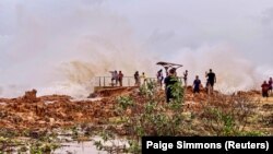 People watch as huge waves brought by Cyclone Veronica crash on the coast in Port Hedland, Western Australia, March 24, 2019, in this image obtained from social media. 