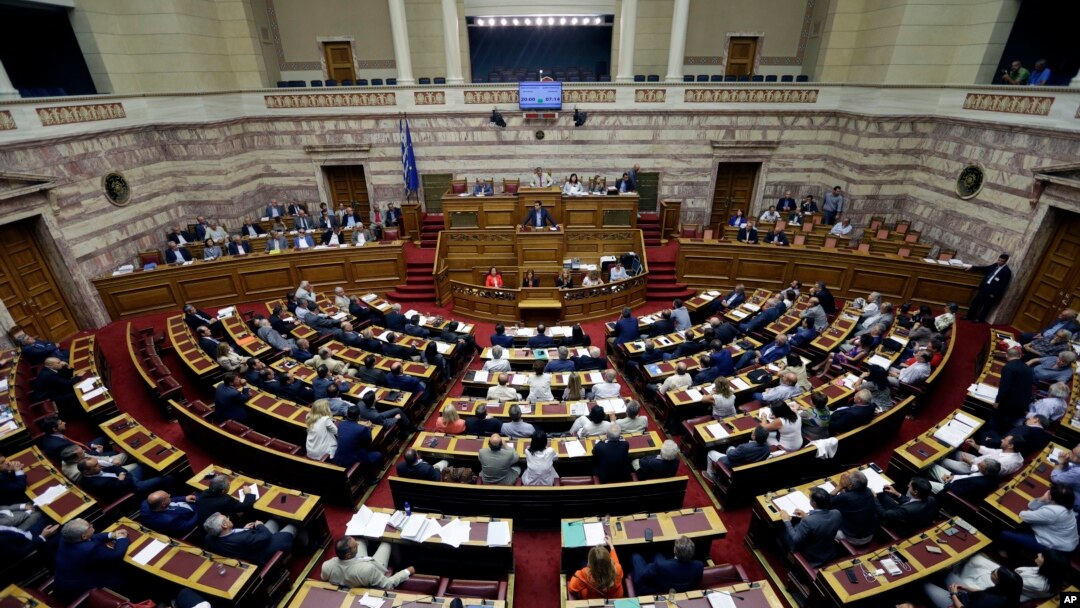FILE - Greece's Prime Minister Alexis Tsipras delivers a speech during an emergency parliament session in Athens, July 23, 2015. 