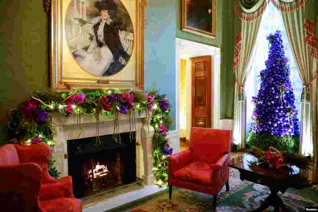 A tree of purple ornaments and flowers is seen in the Green Room during a press event for White House Christmas decorations ahead of holiday receptions by U.S. President Joe Biden and first lady Jill Biden in Washington, U.S. November 29, 2021. REUTERS/Jonathan Ernst