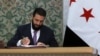 Syrian leader signs constitution putting Islamist group in charge for 5 years