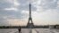 FILE - In this April 24, 2020, photo, a man wears a mask to protect against the spread of the coronavirus as he walks along the Trocadero square close to the Eiffel Tower in Paris.