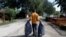 Bence Pardy, 32, carries plastic bags full of waste in Tiszafured, Hungary, Oct. 1, 2019. 