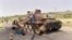FILE - Eritrean children play on a destroyed Ethiopian army tank, June 7, 1991, near Amara, Eritrea.