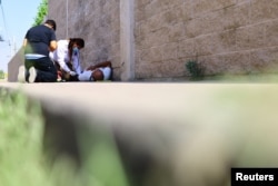 Paramedics attend to a person during a day of high temperatures, in Ciudad Juarez, Mexico June 27, 2023.