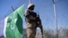 FILE - A Pakistani soldier stands guard next to a fence along Pakistan's border with Afghanistan in Pakistan's South Waziristan tribal district, Oct. 18, 2017. Pakistani officials said on Feb. 18, 2025, that security forces killed 30 Islamist militants in South Waziristan.