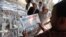 A man reads El-Watan newspaper at Tahrir square in Cairo, May 12, 2013. 