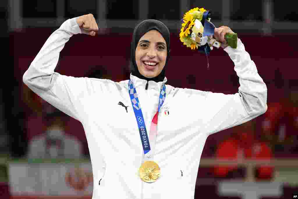 Gold medalist Feryal Abdelaziz of Egypt poses during the medal ceremony for women&#39;s kumite +61kg karate at the 2020 Summer Olympics, Saturday, Aug. 7, 2021, in Tokyo, Japan. (AP Photo/Vincent Thian)