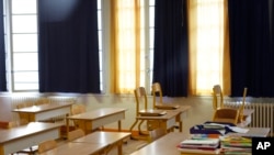 An empty classroom is seen at a closed school in Paris, March 16, 2020.