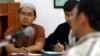 FILE - Bahrun Naim, left, attends his trial at Solo's District Court, Feb. 21, 2011 in this photo taken by Antara Foto. Naim was arrested on suspicion of involvement in a terrorism network in November 2010, and he was convicted in June 2011 of illegal possession of ammunition.