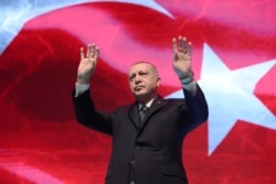 Turkey's President Recep Tayyip Erdogan gestures as he addresses his ruling party members, in Ankara, Turkey, March 2, 2020.