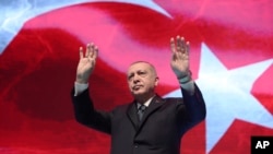 Turkey's President Recep Tayyip Erdogan gestures as he addresses his ruling party members, in Ankara, Turkey, March 2, 2020. 