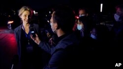 Thea Fischer of the World Health Organization team speaks to journalists outside after a WHO-China Joint Study Press Conference held at the end of the WHO mission in Wuhan, China, Feb. 9, 2021.