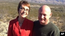 In this photo provided by the office of U.S. Rep. Gabrielle Giffords, Giffords and husband Mark Kelly pose at the Davidson Canyon Gabe Zimmerman Memorial outside of Tucson, Arizona, January 7, 2012.