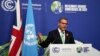 Britain's Alok Sharma, second left, president of the COP26, and Patricia Espinosa, left, UNFCCC executive-secretary applaud during closing plenary session of the COP26 U.N. Climate Summit, Glasgow, Scotland, Nov. 13, 2021.