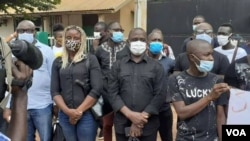 Members of the Union of Journalists and Technicians of the Guinea-Bissau Media, wearing COVID masks, hold a vigil outside Radio Capital FM in Bissau, Guinea-Bissau, Aug. 6, 2020.