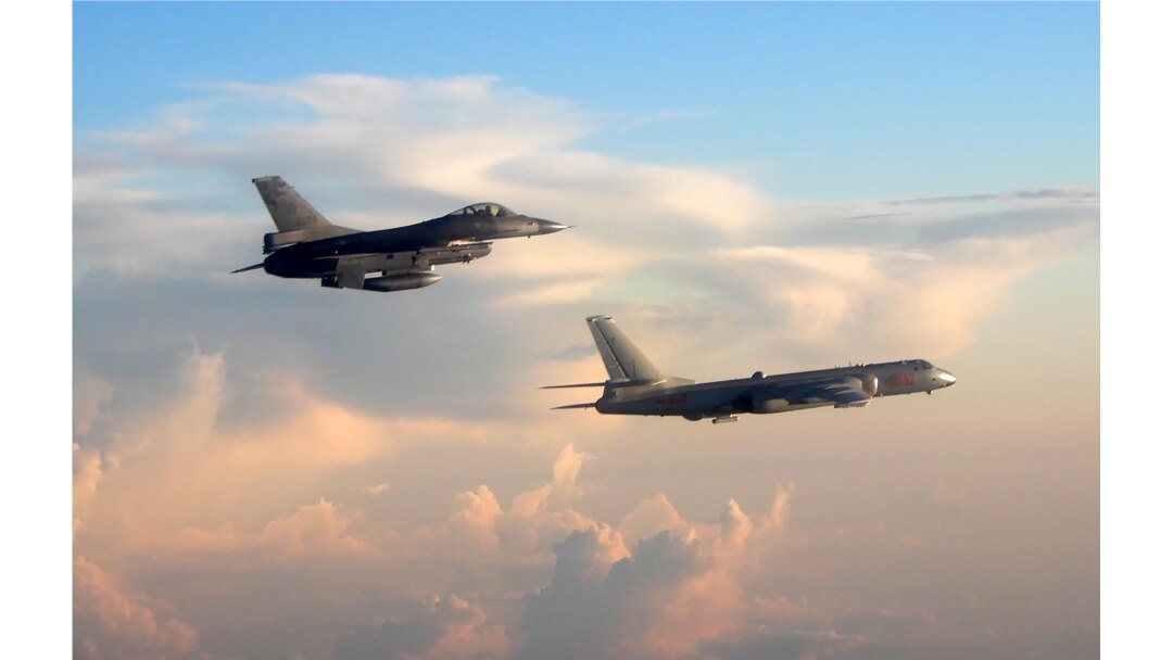 FILE - This photo taken May 25, 2018, by Taiwan's Defense Ministry shows Taiwan's F-16 fighter jet, left, monitoring one of two Chinese H-6 bombers that flew over the Bashi Channel south of Taiwan and the Miyako Strait, near Japan's Okinawa Island.