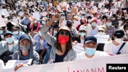 Demonstrators rally outside the Central Bank of Myanmar during a protest against the military coup and to demand the release of elected leader Aung San Suu Kyi, in Yangon, Myanmar, Feb. 11, 2021.