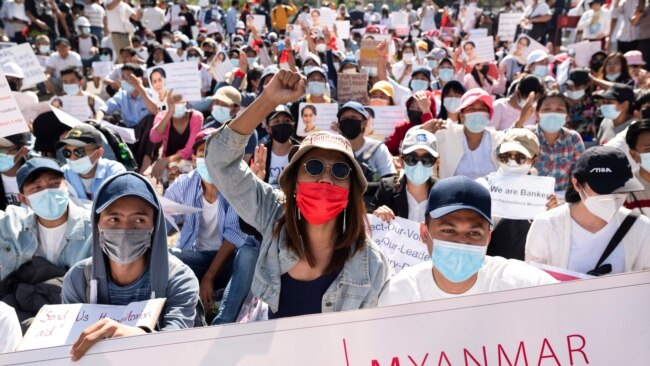 Demonstrators rally outside the Central Bank of Myanmar during a protest against the military coup and to demand the release of elected leader Aung San Suu Kyi, in Yangon, Myanmar, Feb. 11, 2021.