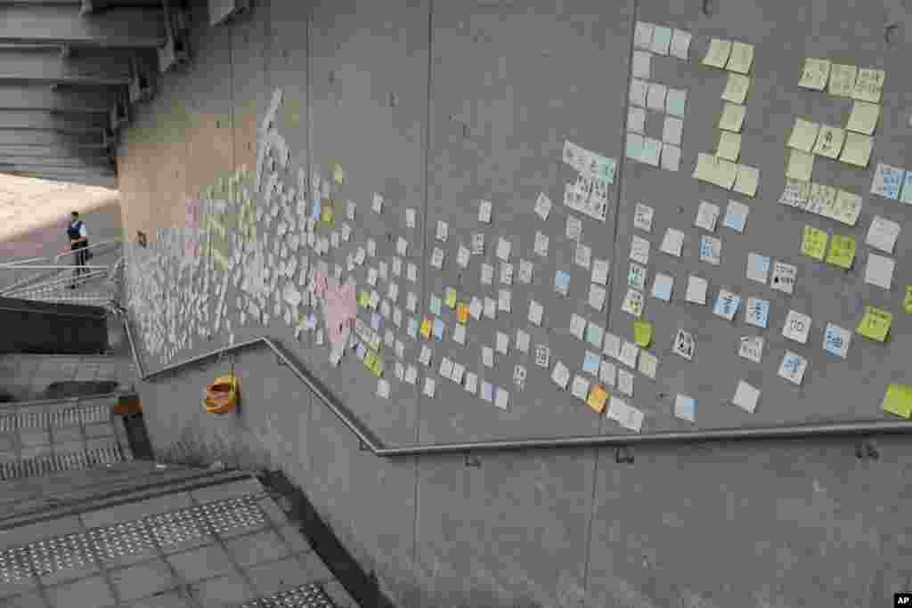 Stickers with messages supporting protesters are left on a wall near the Legislative Council in Hong Kong. Calm returned to the streets following protests by students and human rights activists opposed to a bill that would permit suspects to be tried in mainland Chinese courts.
