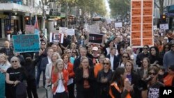 In this image made from video provided by AUBC, people march and shout slogans during a protest against gender-based violence, in Melbourne, Australia, April 28, 2024. Officials met in Canberra Wednesday to discuss ways to address the issue.