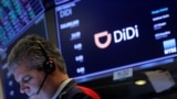 FILE - A trader works during the IPO for Chinese ride-hailing company Didi Global Inc on the New York Stock Exchange floor in New York City, June 30, 2021. 