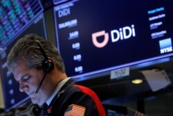 FILE - A trader works during the IPO for Chinese ride-hailing company Didi Global Inc on the New York Stock Exchange floor in New York City, June 30, 2021.