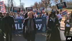 Former New York City Mayor, and Democratic presidential candidate Michael Bloomberg walks with supporters along the route of the Little Rock "marade" marking the Martin Luther King Jr. holiday in Little Rock, Arkansas, Jan. 20, 2020. 