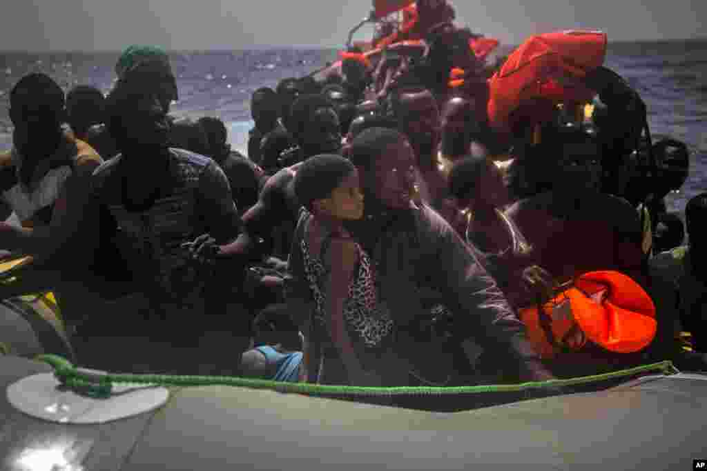 Migrants wait to be rescued by aid workers of Spanish NGO Proactiva Open Arms in the Mediterranean Sea, about 15 miles north of Sabratha, Libya.