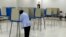 FILE - A voter marks her ballot at the Bowen Center in Pontiac, Michigan, Aug. 7, 2012. 