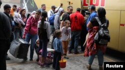 Venezuelan migrants arrive from the northern city of Tumbes, border with Ecuador, to the bus terminal in Lima, Peru, Aug. 22, 2018. 