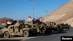 Military vehicles of Kurdish security forces are seen at Mount Sinjar, in the town of Sinjar, Iraq, Dec. 21, 2014.