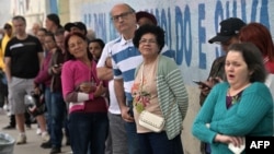 FILE - People line up to vote during the municipal elections runoff in Sao Paulo on Oct. 27, 2024. In Brazil's polarized election environment, women and minority journalists faced a disproportionate number of online and offline attacks.