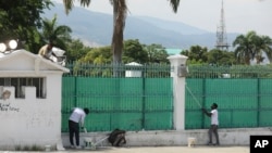 FILE - Workers paint the exterior of the National Palace in Port-au-Prince, Haiti, Sept. 23, 2024.