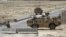 British troops keep watch at a checkpoint, where a man shot and killed three British soldiers, in Helmand province July 2, 2012. The man, an Afghan policeman, shot the soldiers at the checkpoint on Sunday, Afghan officials said, the latest in a chain of i