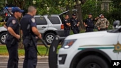 Law enforcement officers man a road block after police officers were shot earlier in the day in Baton Rouge, Louisiana, July 17, 2016. Multiple law enforcement officers were killed and wounded Sunday morning in a shooting near a gas station in Baton Rouge