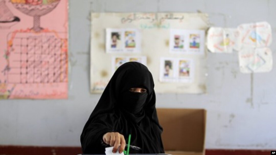 A woman casts her vote during the presidential elections at a polling station in Al Hasaba neighborhood in Sana'a February 21, 2012.