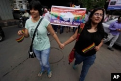 FILE - Members of the lesbian, gay, bisexual and transgender community and their supporters from across India participate in a pride walk in Surat in Gujarat state, India, Oct. 6, 2013. The walk was organized for the first time in the Gujarat state to demand social acceptance and equal rights.