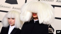 Sia, right, and Maddie Ziegler arrive at the 57th annual Grammy Awards at the Staples Center in Los Angeles, California, Feb. 8, 2015.