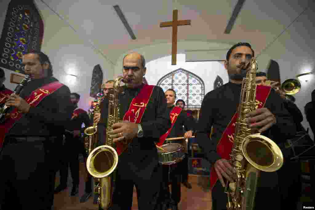 A musical band from Shi'ites community in Bahrain perform at St. Christopher's Cathedral during Christmas Mass in Manama, Bahrain.