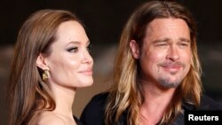  FILE - Hollywood actor Brad Pitt and actress Angelina Jolie make an appearance before fans at the Japan premiere of Pitt's movie 'World War Z' in Tokyo, July 2013.