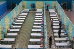 FILE - Indian medical officers inspect a quarantine center at the Sarusojai sports complex in Gauhati, India, March 31, 2020.