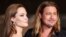  FILE - Hollywood actor Brad Pitt and actress Angelina Jolie make an appearance before fans at the Japan premiere of Pitt's movie 'World War Z' in Tokyo, July 2013.